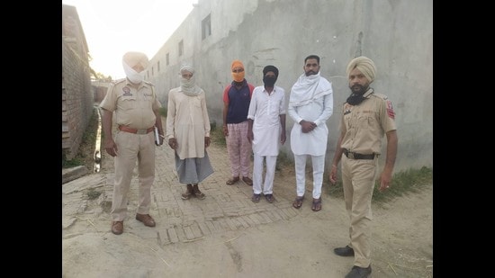 Residents and police personnel during a thikri pehra in a village. Residents and police personnel during a thikri pehra in a village.