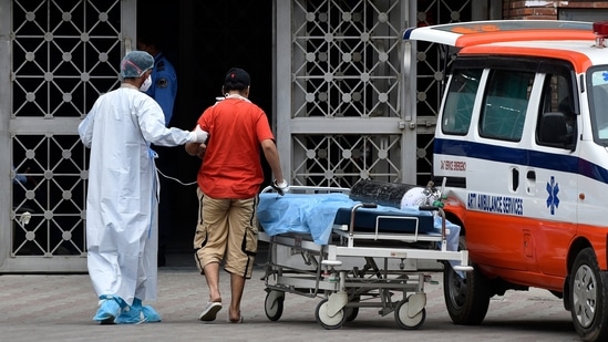 A Covid-19 patient is assisted into an ambulance while being discharged from Lok Nayak Jai Prakash (LNJP) hospital in New Delhi on May 18. Earlier on May 18, the country saw its highest ever recoveries with 4,22,436 fresh discharges in a single day for the first time. (Sanjeev Verma / HT Photo) A Covid-19 patient is assisted into an ambulance while being discharged from Lok Nayak Jai Prakash (LNJP) hospital in New Delhi on May 18. Earlier on May 18, the country saw its highest ever recoveries with 4,22,436 fresh discharges in a single day for the first time. (Sanjeev Verma / HT Photo)