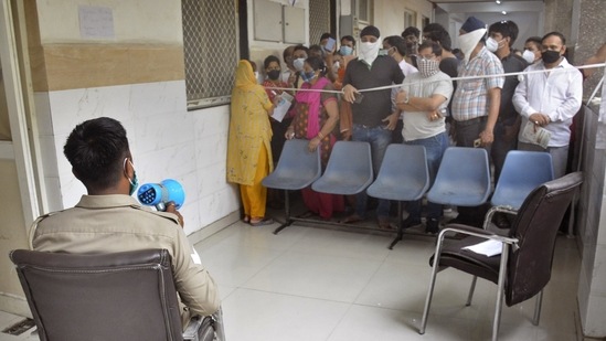 A police personnel makes social distancing announcements to a crowd of people looking to get vaccinated against Covid-19 at MMG Hospital in Ghaziabad on May 18. Daily testing for the virus also hit a record 20 lakh samples on May 18, figures from the state-run Indian Council of Medical Research showed. (Sakib Ali / HT Photo) A police personnel makes social distancing announcements to a crowd of people looking to get vaccinated against Covid-19 at MMG Hospital in Ghaziabad on May 18. Daily testing for the virus also hit a record 20 lakh samples on May 18, figures from the state-run Indian Council of Medical Research showed. (Sakib Ali / HT Photo)