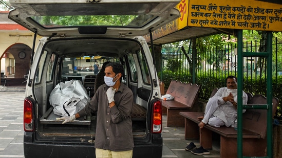 An ambulance driver waits to handover the body of a Covid-19 victim to the relatives, at Lodhi Road crematorium in New Delhi on May 17. India’s daily pandemic death toll has been rising in recent days as cases spread into rural districts with poor health facilities. (Amal KS / HT Photo) An ambulance driver waits to handover the body of a Covid-19 victim to the relatives, at Lodhi Road crematorium in New Delhi on May 17. India’s daily pandemic death toll has been rising in recent days as cases spread into rural districts with poor health facilities. (Amal KS / HT Photo)