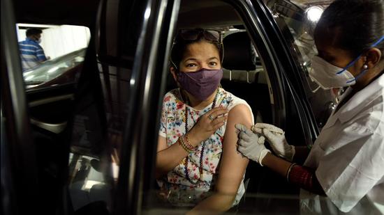 A BMC medic inoculates a beneficiary against Covid-19 at a drive-in vaccination centre, in Mumbai earlier this month. (HT file) A BMC medic inoculates a beneficiary against Covid-19 at a drive-in vaccination centre, in Mumbai earlier this month. (HT file)