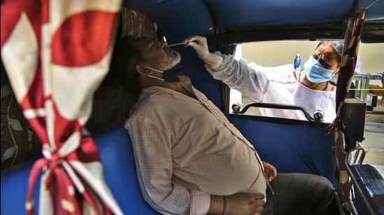 A health worker takes a nasal swab sample of a man to test for Covid in Jammu on Wednesday. (AP) A health worker takes a nasal swab sample of a man to test for Covid in Jammu on Wednesday. (AP)