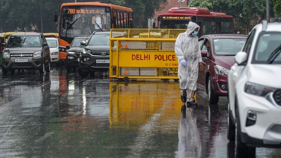 A policeman checks vehicles amid a mild shower at Connaught Place, in New Delhi, Wednesday, May 19, 2021. (PTI) A policeman checks vehicles amid a mild shower at Connaught Place, in New Delhi, Wednesday, May 19, 2021. (PTI)