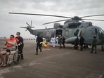 A man gestures after he was rescued by Indian Navy personnel from a sunken barge in the Arabian Sea in the aftermath of Cyclone Tauktae's landfall.