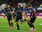 Liverpool's Nathaniel Phillips celebrates scoring their second goal with Roberto Firmino.