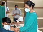 A medical professional administers an anti-Covid vaccine to a youth at Rohtak PGIMS.(HT file photo) A medical professional administers an anti-Covid vaccine to a youth at Rohtak PGIMS.(HT file photo)