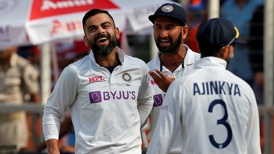 India's captain Virat Kohli celebrates with his teammates Cheteshwar Pujara and Ajinkya Rahane (REUTERS)