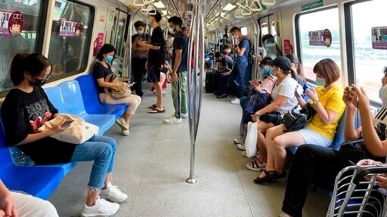 Commuters wear face masks and practice social distancing while onboard a subway on Wednesday. (AP Photo) Commuters wear face masks and practice social distancing while onboard a subway on Wednesday. (AP Photo)