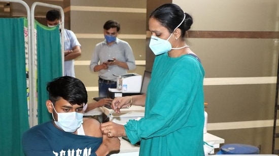 A medical professional administers an anti-Covid vaccine to a youth at Rohtak PGIMS.(HT file photo) A medical professional administers an anti-Covid vaccine to a youth at Rohtak PGIMS.(HT file photo)
