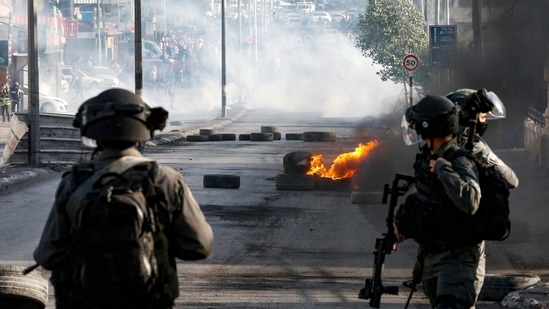 Israeli troops take position during confrontations with Palestinian protesters in the occupied West Bank city of Bethlehem, on May 20, 2021. (AFP) Israeli troops take position during confrontations with Palestinian protesters in the occupied West Bank city of Bethlehem, on May 20, 2021. (AFP)