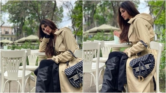 Another stunning look from her trip to Odessa had the actor wearing a dress teamed with stocking, a pair of black knee-length boots, a beige trench coat and her Christian Dior saddle bag.(Instagram/ imouniroy)
