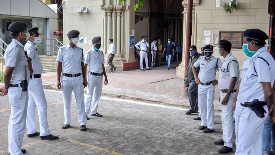 Police personnel guard at the Calcutta High Court, during a hearing on the Narada scam case, in Kolkata on May 19, 2021. (PTI) Police personnel guard at the Calcutta High Court, during a hearing on the Narada scam case, in Kolkata on May 19, 2021. (PTI)