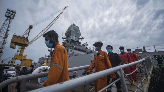 Crew members of ONGC's Barge P305 who were stranded in the Mumbai offshore due to Cyclone Tauktae, coming out of INS Kochi after they were rescued by the Indian Navy, at Naval Dockyard, in Mumbai on Wednesday, May 19. (Pratik Chorge/HT photo)