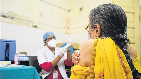 A health worker prepares a vaccine dose for a beneficiary at Kalawatibai Mavale hospital in Narayanpeth, on Wednesday. (HT) A health worker prepares a vaccine dose for a beneficiary at Kalawatibai Mavale hospital in Narayanpeth, on Wednesday. (HT)