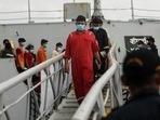 People who were stranded at sea aboard barge P305 due to Cyclone Tauktae exit the INS Kochi after they were rescued by the Indian Navy, at Naval Dockyard in Mumbai.