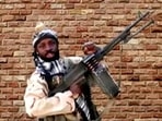Boko Haram leader Abubakar Shekau holds a weapon in an unknown location in Nigeria.