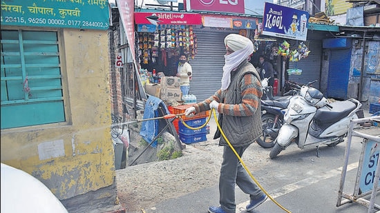 A man carrying out a sanitisation drive at Sanjauli market in Shimla on Friday. (Deepak Sansta/HT) A man carrying out a sanitisation drive at Sanjauli market in Shimla on Friday. (Deepak Sansta/HT)