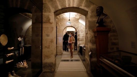 Journalists walk in the rooms devoted to Parisian history from the prehistoric period and Middle-Ages at the Carnavalet-History of Paris Museum, located in the Marais district, during a press visit after four years of renovations in Paris, France, May 20, 2021.  (REUTERS)