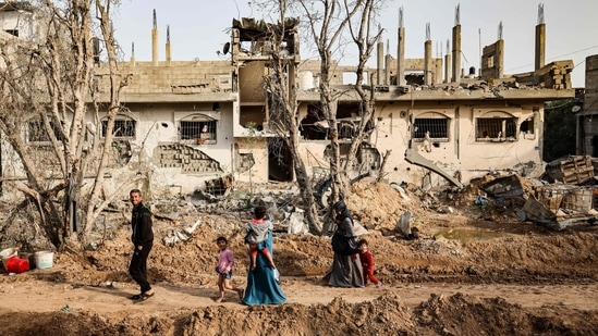 Palestinians return to her neighbourhood hit by Israeli bombardment in Gaza City, after the ceasefire, on May 21. Israel said it had killed at least 160 combatants, but Hamas cast the fighting as successful resistance to a militarily and economically stronger foe, Reuters reported.(Mohammed Abed / AFP)