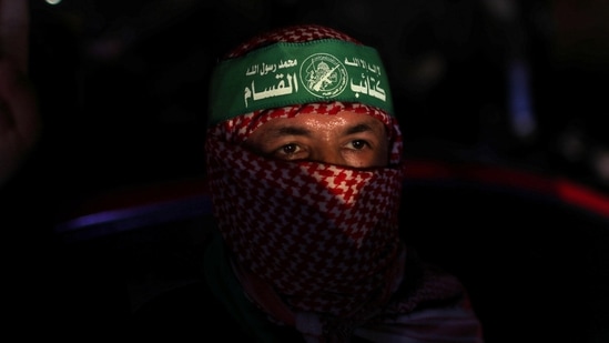 A man looks on as Palestinians celebrate in the streets following a ceasefire, in Gaza City on May 21. "It is true the battle ends today but Netanyahu and the whole world should know that our hands are on the trigger and we will continue to grow the capabilities of this resistance," said Ezzat El-Reshiq, a senior member of the Hamas political bureau, referring to Israel's prime minister, Benjamin Netanyahu, Reuters reported.(Mohammed Salem / REUTERS)