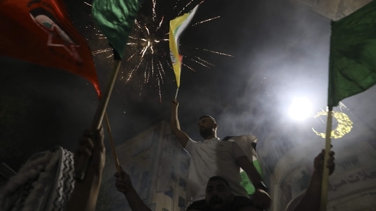 The fighting meant many Palestinians in Gaza could not mark the Eid al-Fitr festival at Ramadan's conclusion. On Friday, throughout Gaza, postponed Eid al-Fitr meals were held instead. (Photo by ABBAS MOMANI / AFP)(AFP)