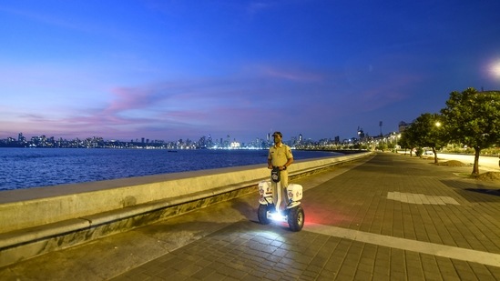A police man patrols at the Marine Drive during restrictions imposed by the state government amid surge in Covid-19 cases, in Mumbai. (PTI Photo) A police man patrols at the Marine Drive during restrictions imposed by the state government amid surge in Covid-19 cases, in Mumbai. (PTI Photo)