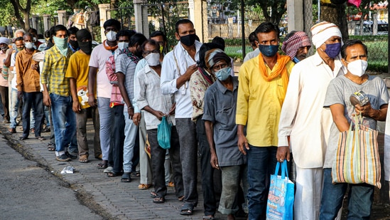 People wait in a queue for food distributed by volunteers, during the ongoing Covid-19 lockdown in Nagpur, on Monday.(PTI Photo)