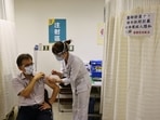 A nurse administers a dose of the AstraZeneca vaccine against the coronavirus disease (Covid-19) during a vaccination session.