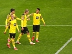 Dortmund's Erling Haaland, second right, celebrates with teammates after scoring his side's third goal during the German Bundesliga match. Dortmund's Erling Haaland, second right, celebrates with teammates after scoring his side's third goal during the German Bundesliga match.