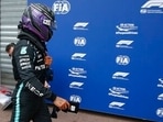 Mercedes driver Lewis Hamilton of Britain walks near his team garage after the qualifying session at the Monaco racetrack.