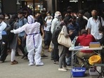 Karnataka, Maharashtra and Kerala witnessed a decline in their respective active caseload since Friday. In picture - Health worker directs arriving passengers towards Covid-19 testing counter outside a train station in Bengaluru. Karnataka, Maharashtra and Kerala witnessed a decline in their respective active caseload since Friday. In picture - Health worker directs arriving passengers towards Covid-19 testing counter outside a train station in Bengaluru.
