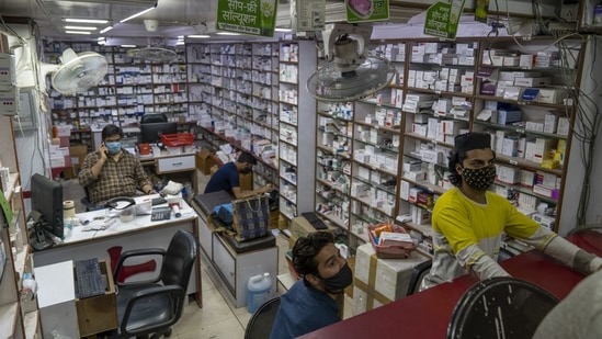 People wear protective masks in a store at the Bhagirath Palace wholesale medicine market in New Delhi. (Bloomberg) People wear protective masks in a store at the Bhagirath Palace wholesale medicine market in New Delhi. (Bloomberg)