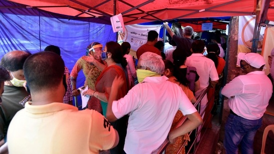 Beneficiaries crowding at a Covid-19 vaccination centre, at the SDMC Dispensary in Nehru Nagar, New Delhi on May 18. Overall, about 26% of the population has received at least one dose -- the latest electoral rolls put Delhi adult population at about 15 million -- although the recipients are likely to include people from neighbouring NCR towns of Noida, Ghaziabad, and Gurugram.(Sanjeev Verma / HT Photo)