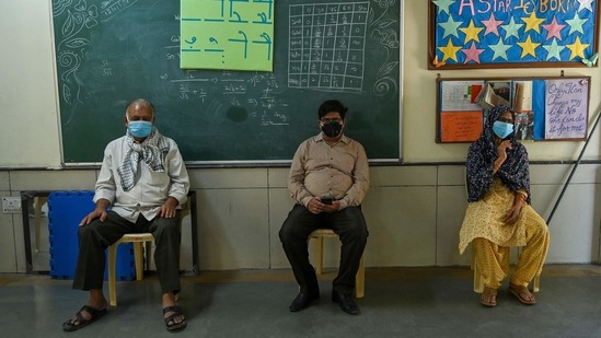Beneficiaries sitting under observation after receiving a dose of a Covid-19 vaccine in New Delhi on May 22. For the month of May, India has a cumulative supply of 73 million doses, Union government officials had said earlier this month.(Prakash Singh / AFP)