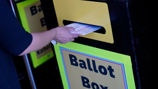 A person places a mail-in ballot in a drop box at the Clark County Election Department in Las Vegas.(AP) A person places a mail-in ballot in a drop box at the Clark County Election Department in Las Vegas.(AP)