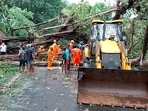 NDRF team clears a road blocked by the falling of trees due to strong winds during the formation of cyclone Tauktae, near TB hospital in Panaji.(PTI) NDRF team clears a road blocked by the falling of trees due to strong winds during the formation of cyclone Tauktae, near TB hospital in Panaji.(PTI)
