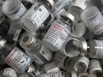 Empty vials of the Moderna COVID-19 vaccine lie in a box. 
