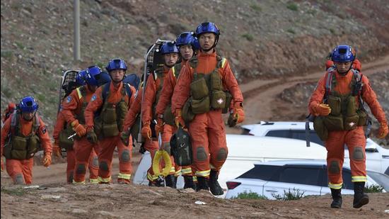 In this photo provided by China's Xinhua News Agency, rescuers walk into the accident site to search for survivors in Jingtai County of Baiyin City, northwest China's Gansu province, on Sunday. (AP)