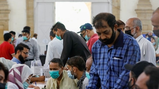 FILE PHOTO: People gather to receive their coronavirus disease (Covid-19) vaccine doses, at a vaccination center in Karachi, Pakistan (REUTERS).