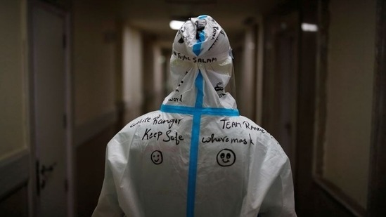 A message is written on the back of a medical staff member by a colleague at the Intensive Care Unit (ICU) ward, where patients suffering from coronavirus disease (Covid-19) are being treated in Greater Noida. (Reuters)