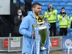 Manchester City's Sergio Aguero walks back out on to the pitch for a presentation with the trophy.(Pool via REUTERS)
