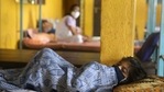 A patient suffering from coronavirus disease (Covid-19) rests inside a classroom turned Covid care facility on the outskirts of Mumbai.(Reuters)