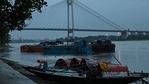 A man ties a boat on the side of the Ganga river in view of the upcoming Cyclone Yaas as rain clouds loom over the sky of Kolkata on May 24, 2021. (AFP) A man ties a boat on the side of the Ganga river in view of the upcoming Cyclone Yaas as rain clouds loom over the sky of Kolkata on May 24, 2021. (AFP)