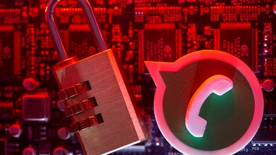 A 3D printed Whatsapp logo and a padlock are placed on a computer motherboard in this illustration picture taken May 4, 2021. (REUTERS)