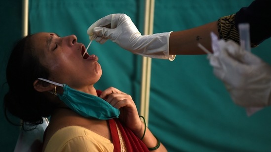 A healthcare worker collects swab samples of citizens for Covid-19 test at NMMC Hospital, Vashi, in Navi Mumbai. (Bachchan Kumar/HT Photo) A healthcare worker collects swab samples of citizens for Covid-19 test at NMMC Hospital, Vashi, in Navi Mumbai. (Bachchan Kumar/HT Photo)