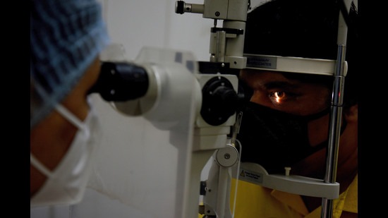 A doctor examining an eye of a patient. Symptoms of black fungus infection can include pain or swelling of the eye, fever, shortness of breath, headache, altered sensorium, double or blurred vision. (HT PHOTO) A doctor examining an eye of a patient. Symptoms of black fungus infection can include pain or swelling of the eye, fever, shortness of breath, headache, altered sensorium, double or blurred vision. (HT PHOTO)