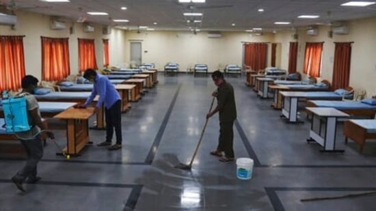 Workers disinfect an isolation center for Covid-19 positive people in Hyderabad, on Monday, May 3, 2021. Workers disinfect an isolation center for Covid-19 positive people in Hyderabad, on Monday, May 3, 2021.