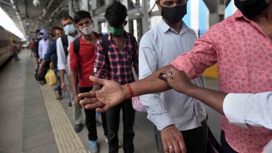 Healthcare workers stamp the hands of travellers arriving via outstation trains at Lokmanya Tilak Terminus in Mumbai on May 22. Recoveries climbed to 23,728,011 while active cases are at 2,720,716, down 84,683 from the previous bulletin. (Satish Bate / HT Photo) Healthcare workers stamp the hands of travellers arriving via outstation trains at Lokmanya Tilak Terminus in Mumbai on May 22. Recoveries climbed to 23,728,011 while active cases are at 2,720,716, down 84,683 from the previous bulletin. (Satish Bate / HT Photo)