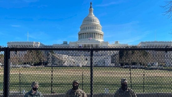 US National Guard soldiers guarding the grounds of the US Capitol from behind a security fence in Washington, DC, on January 9, 2021. US National Guard soldiers guarding the grounds of the US Capitol from behind a security fence in Washington, DC, on January 9, 2021.