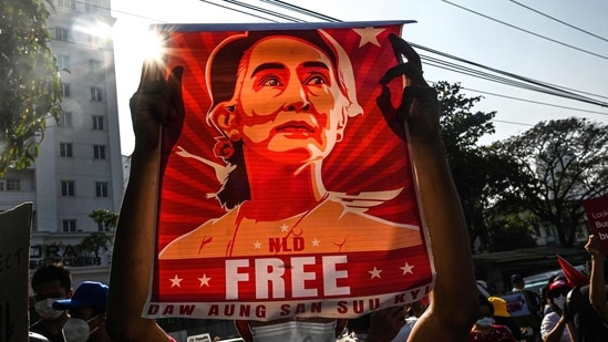 A protester holds up a poster featuring Aung San Suu Kyi during a demonstration against the military coup at in front of the Central Bank of Myanmar in Yangon.